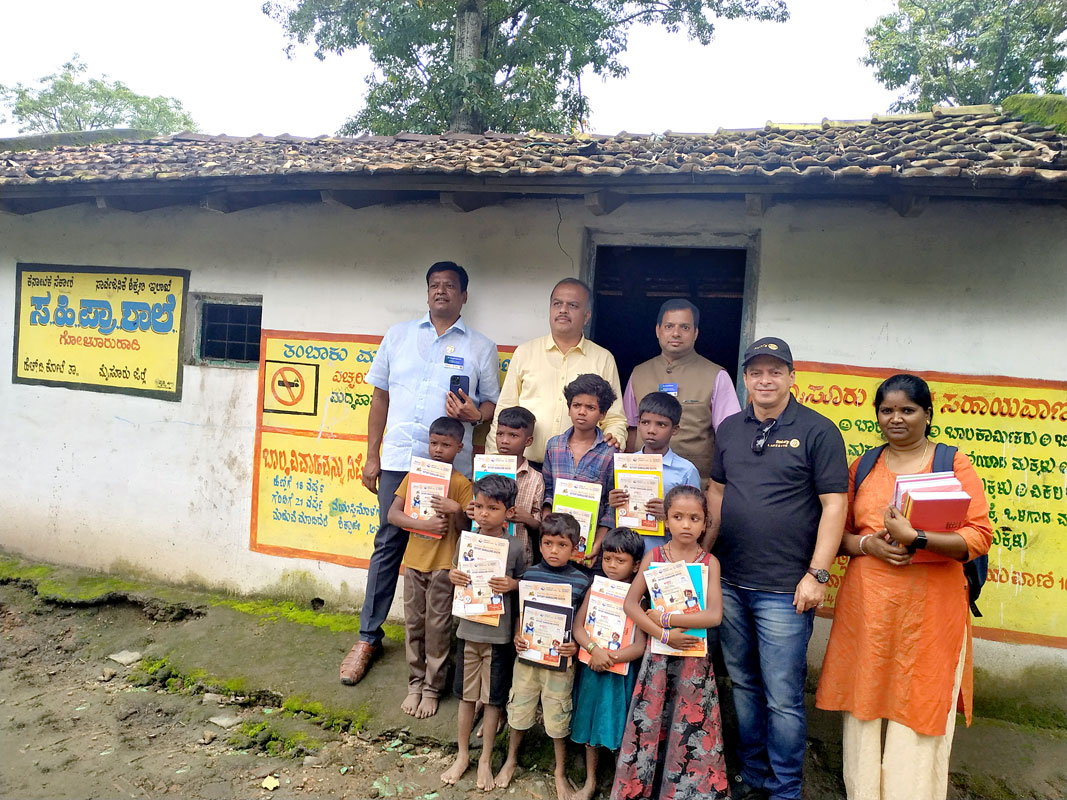Rotarians Srinath Gupta, Gurunagesh, Anil Dsouza, Kashinath Prabhu and Mangala, a contact from a local NGO, with children in a tribal village.