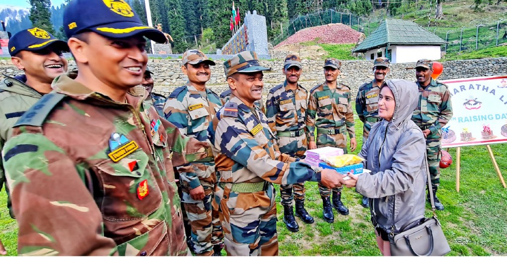 Seema, spouse of DGE Arun Bhargava, gives sweets to Army personnel.