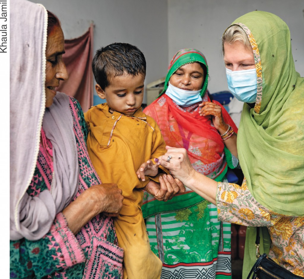 RI President Jennifer Jones interacts with a child after giving him a polio vaccine at a home in Karachi, Pakistan.