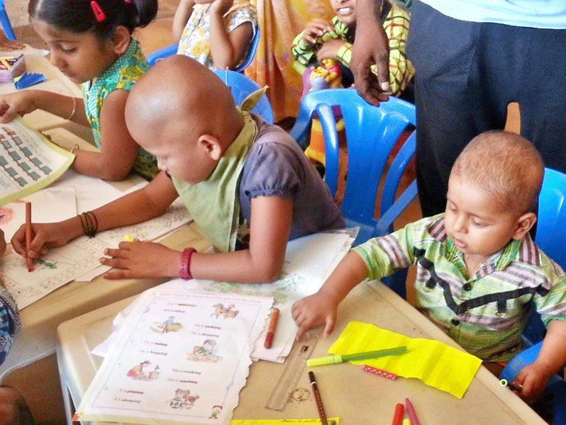 Cancer afflicted children work on their colouring books.
