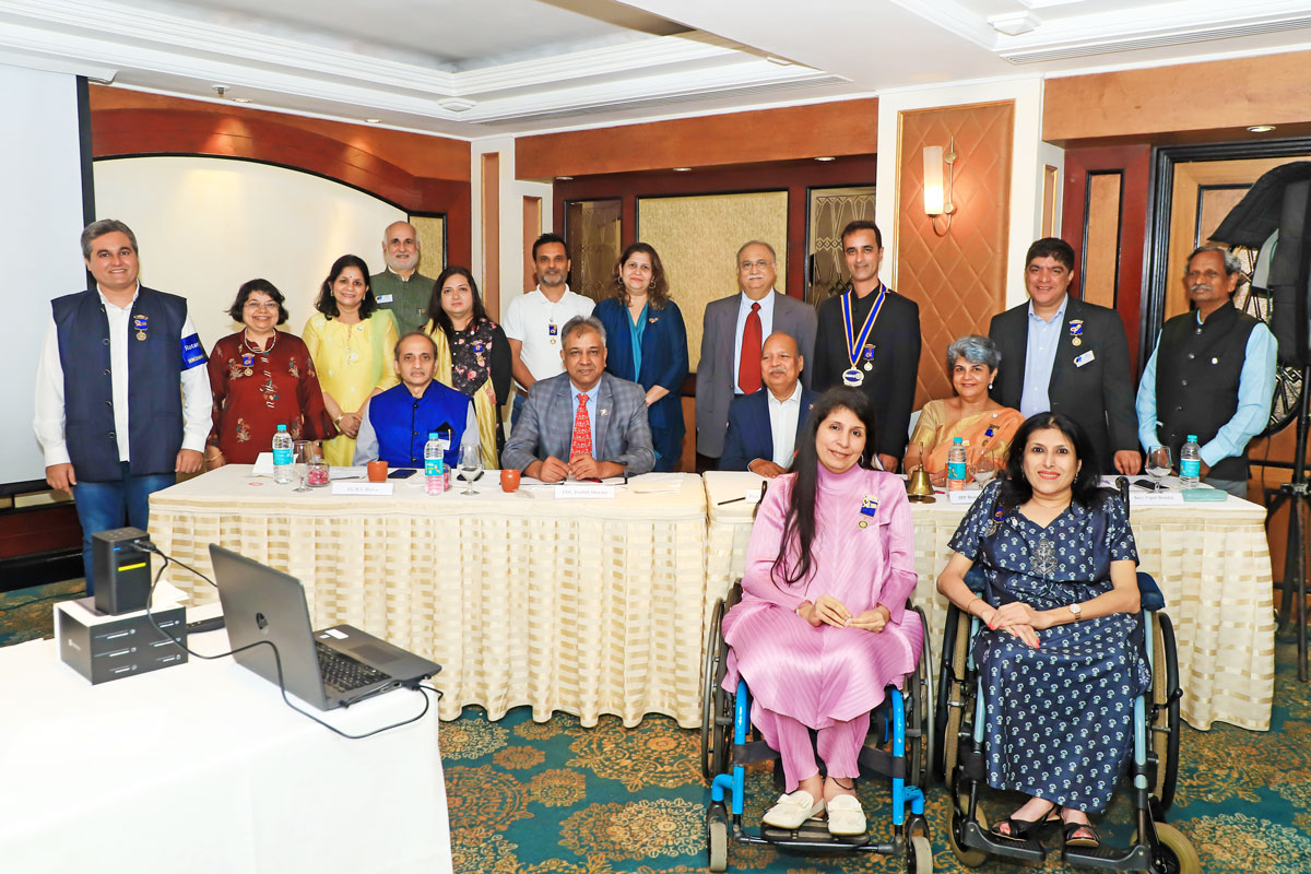 Sunita and Neenu Kewlani during their induction into RC Mumbai Bravehearts. PDG Prafull Sharma (seated, second from L) and club president Khuzem Sakarwala (standing, third from R) are also seen.