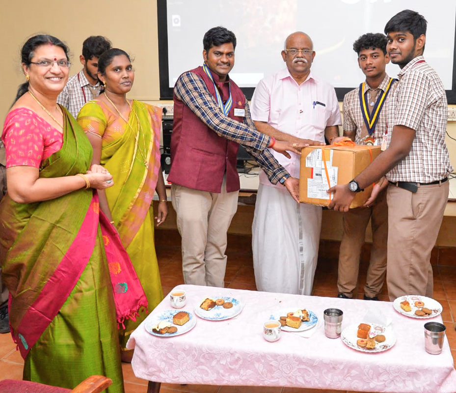 Interact club president Aashiv Muthusuthan gives dress material to RC SPIC Nagar president Arun Jeyakumar (3rd from L) in the presence of DG V R Muthu (centre) and school principal G Meenakumari (left) to be delivered to a special home.