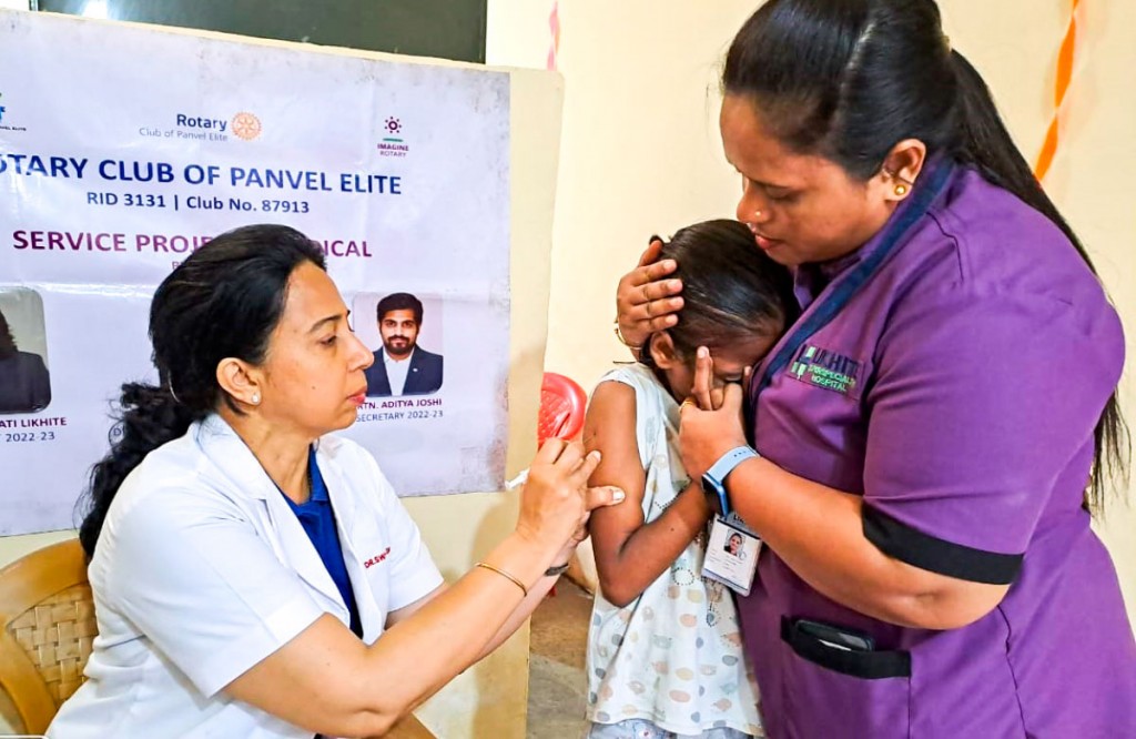 Club president Dr Swathi Likhite (left) administering a typhoid vaccination to a child.