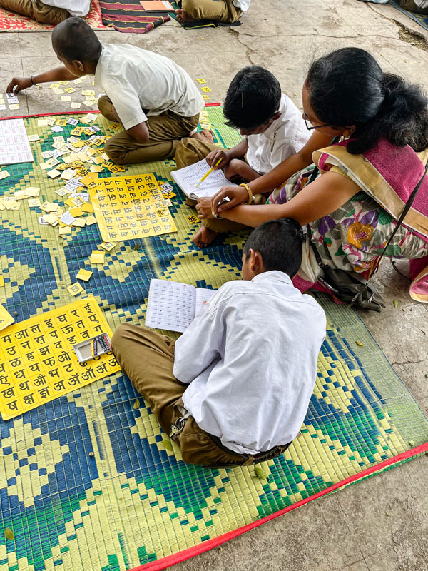 Children learn to read and write in Hindi at one of the classes. 
