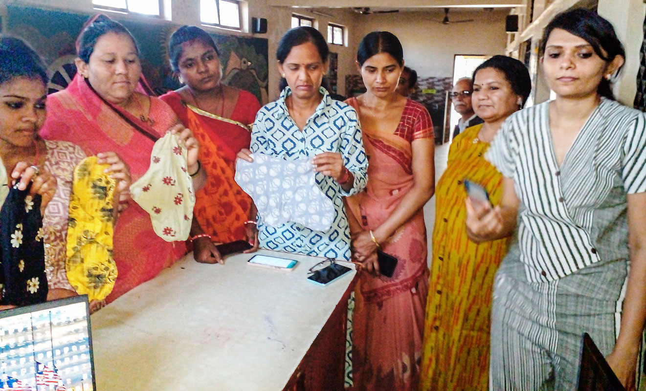 Women display the cloth sanitary napkins they stitched at the Jeevantirth Foundation. 