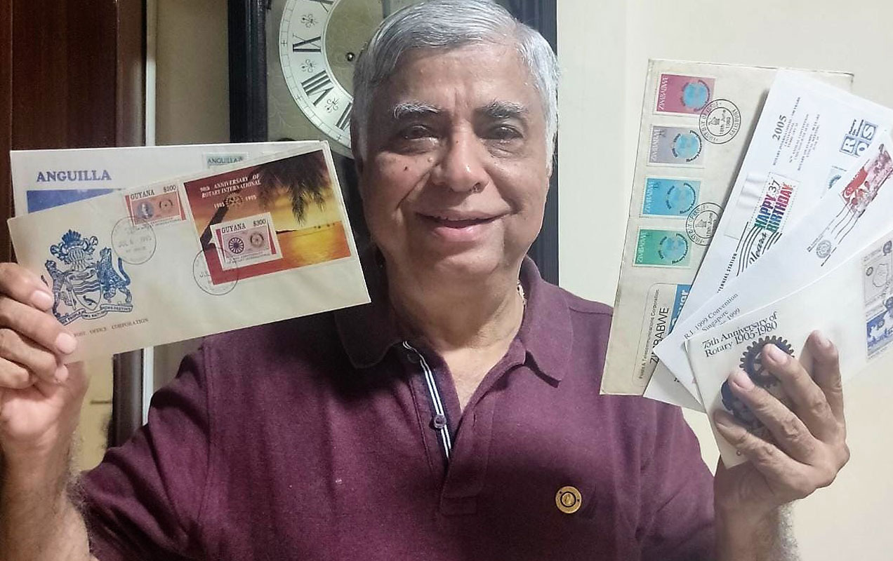 Merchant with some of the first day covers from his collection.