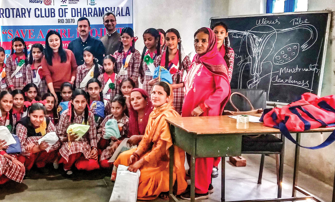 Sanitary pad packets distributed to students after lessons in menstruation. Volunteer doctor Dr Histy, club members Ajay Sharma and Ashwani Sharma are present in the picture.