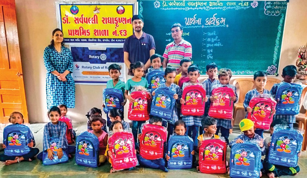 Students display their new school bags.
