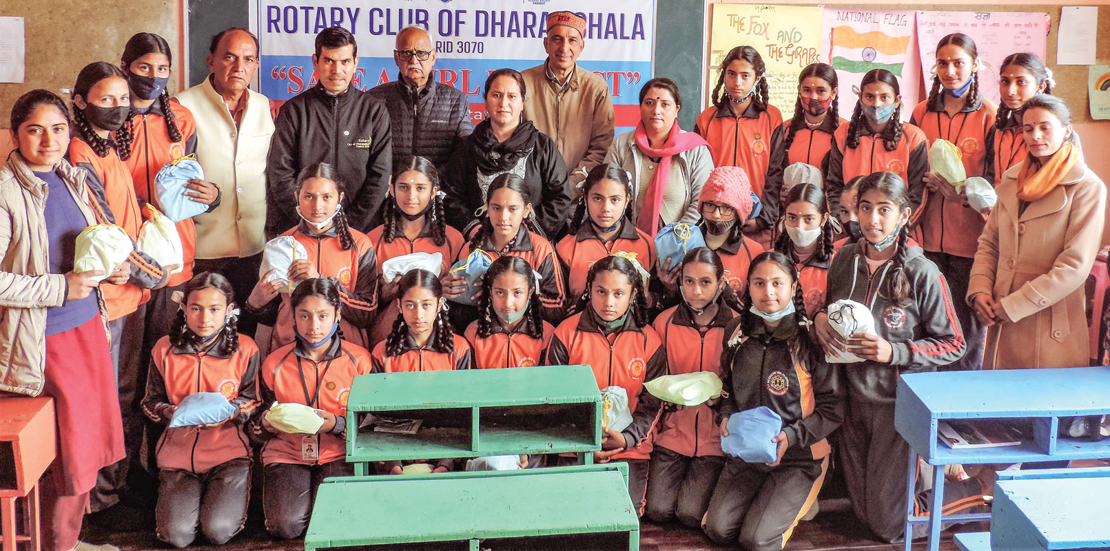 Members of RC Dharamshala (from L) Hari Singh, Milap Nehria, Sangram Guleria, Dr Harmeet Kaur and Y K Dogra with students after distributing reusable sanitary pads to them.