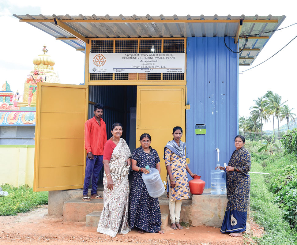 Mastenalli gram panchayat president Rojamma (second left) with villagers in front of the RO plant installed by Rotary at the Marapanalli village.
