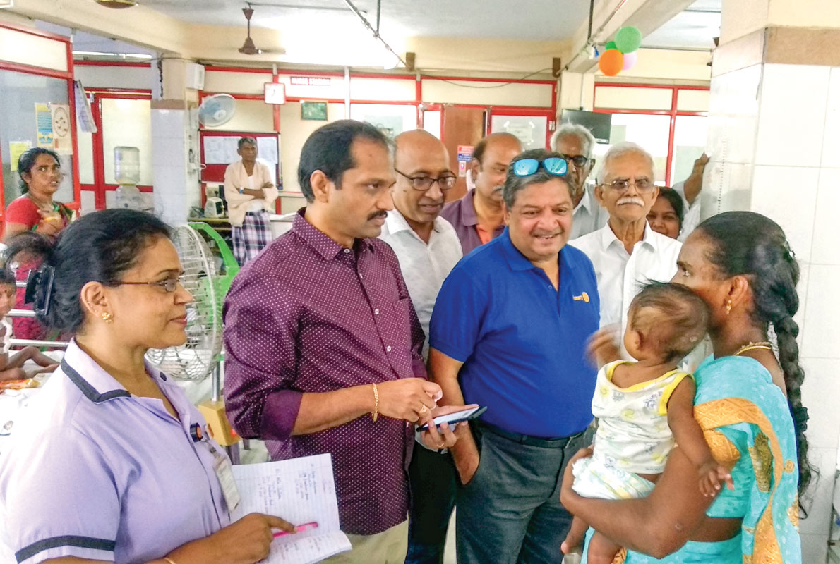 Saravanan with PDGs Natarajan Nagoji and late Raja Ramakrishnan interacting with a mother at the hospital ward.