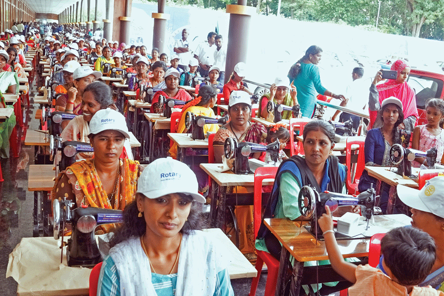 Beneficiaries with sewing machines.