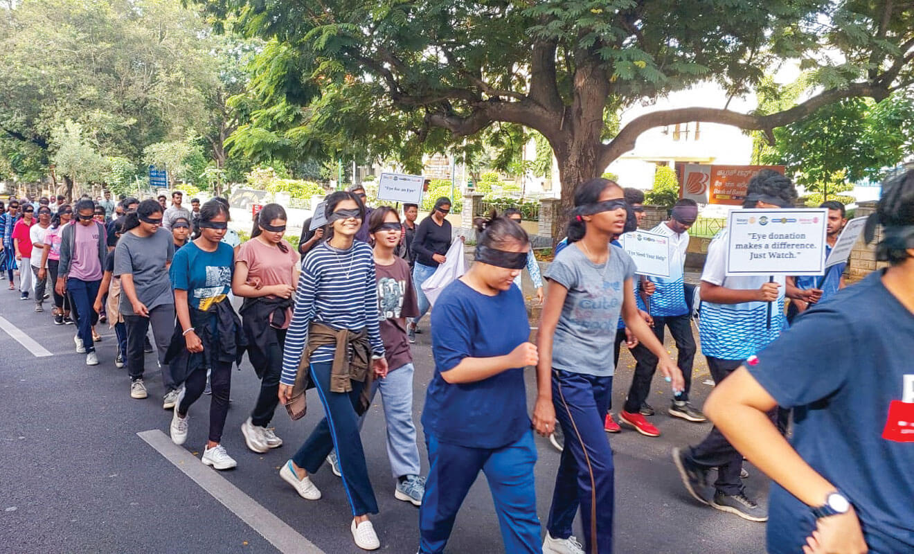 College students participating in the march with their eyes blindfolded. 