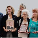 Mark Maloney (left) presents John Sever’s wife, Gerane (centre), with the International Service Award for a Polio-Free World. IPPC chair Michael McGovern is on the right.